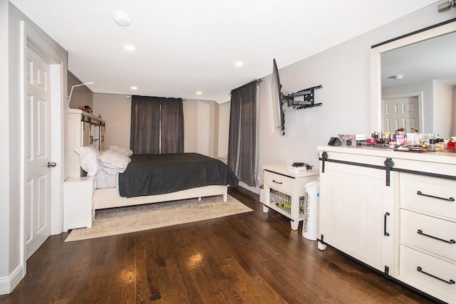 bedroom with dark hardwood / wood-style flooring