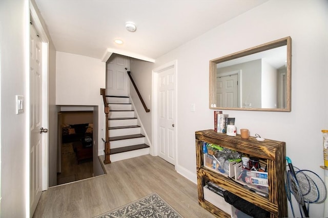 stairs with hardwood / wood-style floors