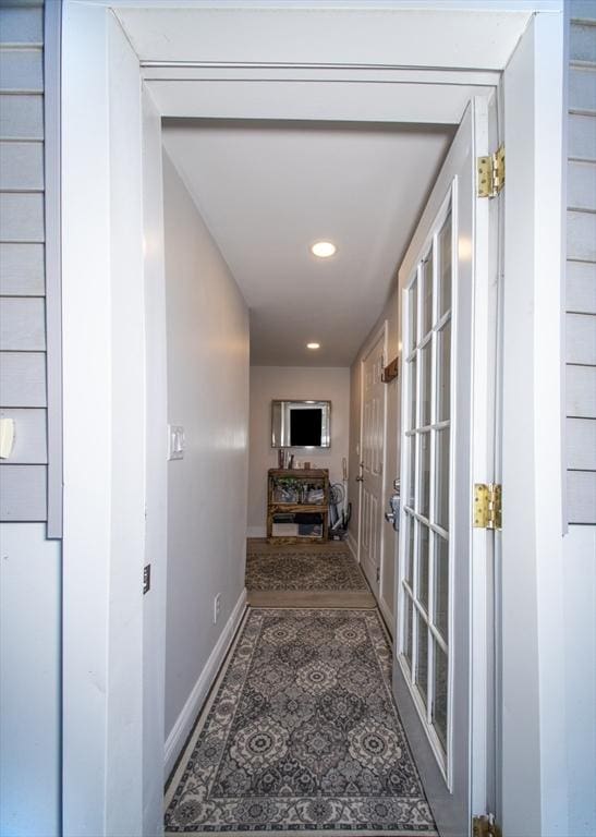 hall with tile patterned floors