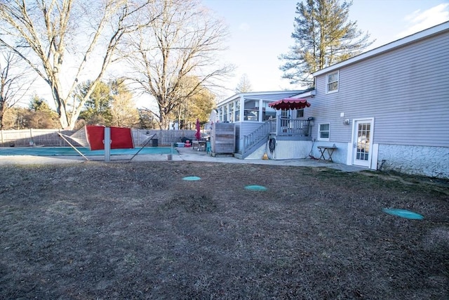 view of yard with a fenced in pool, a patio, and a sunroom