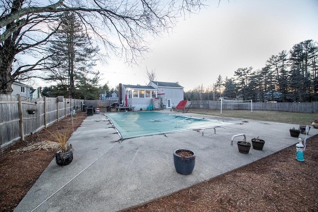 view of swimming pool with a storage shed and a patio