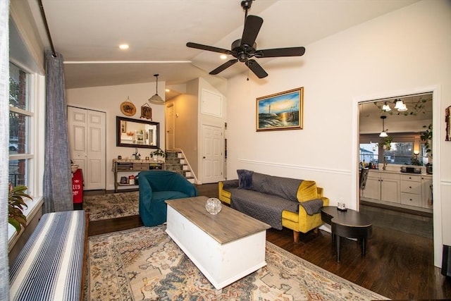 living room featuring dark wood-type flooring, ceiling fan, and lofted ceiling