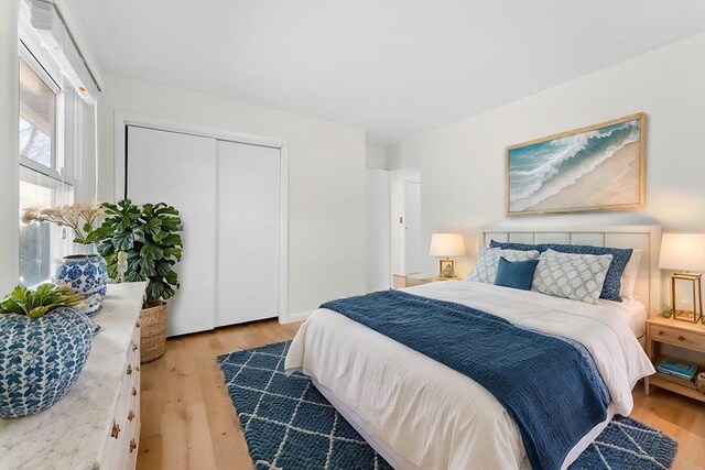 bedroom featuring a closet and light wood-type flooring