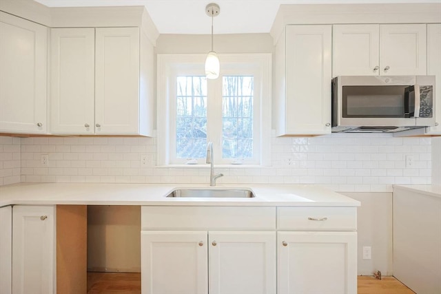 kitchen featuring white cabinetry and sink