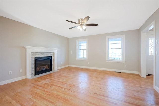 unfurnished living room with ceiling fan and light wood-type flooring