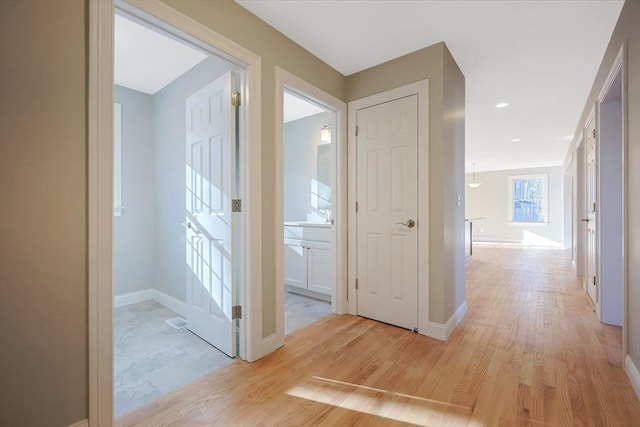 corridor with light hardwood / wood-style flooring