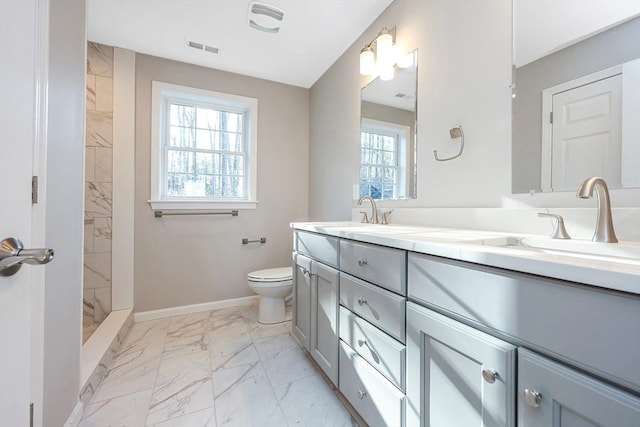 bathroom featuring walk in shower, vanity, a healthy amount of sunlight, and toilet