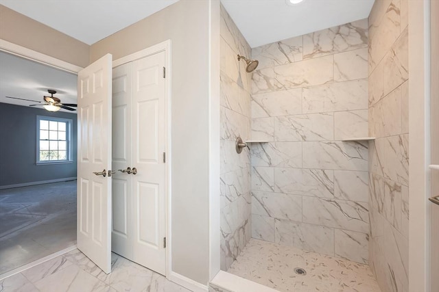 bathroom featuring ceiling fan and a tile shower