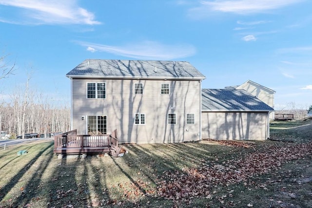 back of property with a lawn and a deck