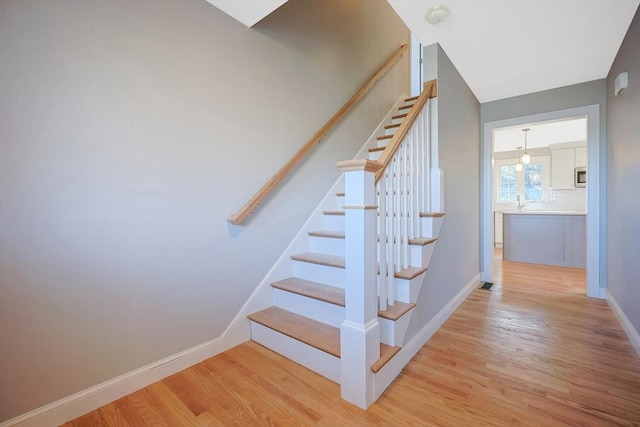 stairway with wood-type flooring