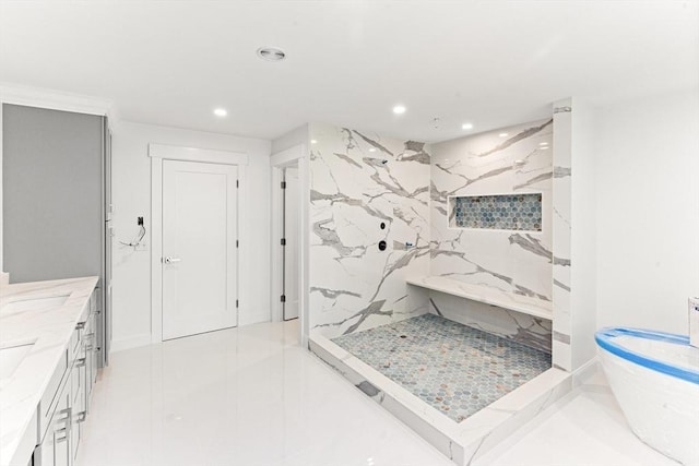 bathroom featuring recessed lighting, a marble finish shower, and vanity