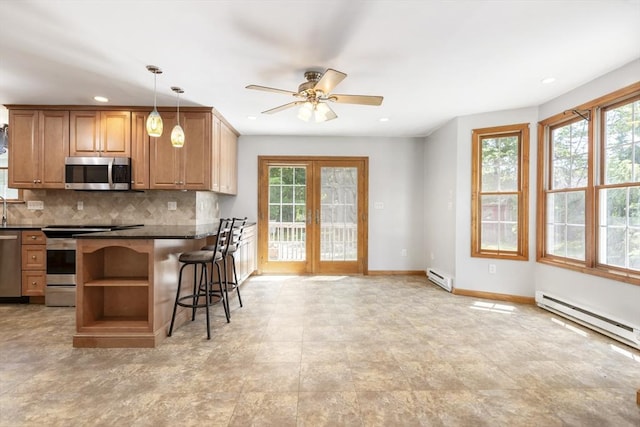 25 Hamilton Rd, Northborough, MA 01532 - kitchen with stainless steel appliances, dark countertops, plenty of natural light, baseboard heating, and recessed lighting