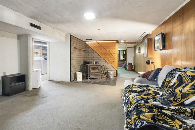 25 Hamilton Rd, Northborough, MA 01532 - living room with wooden walls, a wood stove, carpet flooring, ornamental molding, and washer and clothes dryer