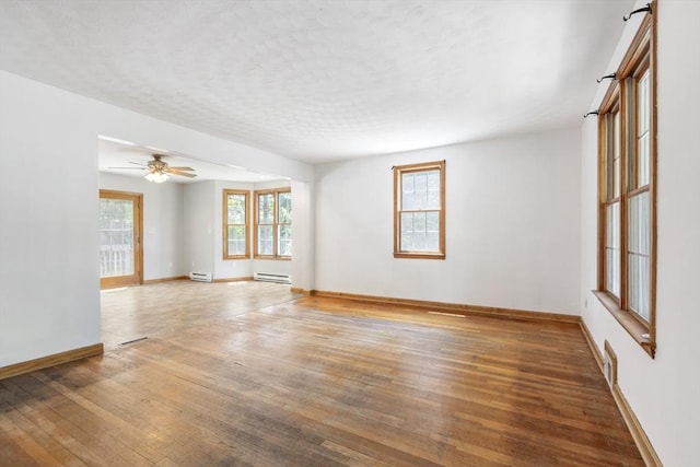 25 Hamilton Rd, Northborough, MA 01532 - spare room featuring a baseboard heating unit, wood-type flooring, ceiling fan, and a textured ceiling