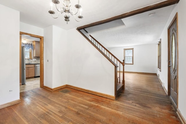 25 Hamilton Rd, Northborough, MA 01532 - corridor with wood-type flooring, a chandelier, and stairs