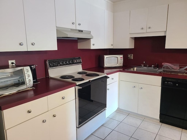 kitchen with white appliances, light tile patterned floors, a sink, under cabinet range hood, and white cabinetry