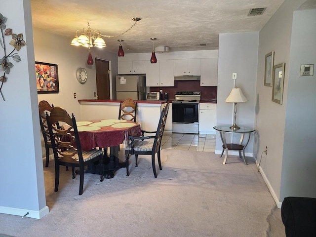 dining room with light carpet, a notable chandelier, baseboards, and visible vents