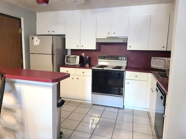 kitchen featuring under cabinet range hood, dark countertops, white appliances, white cabinets, and light tile patterned flooring