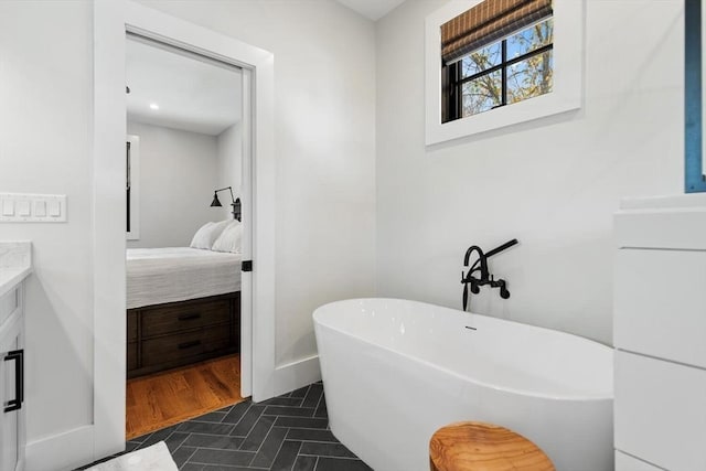 bathroom with vanity, a bathtub, and tile patterned floors