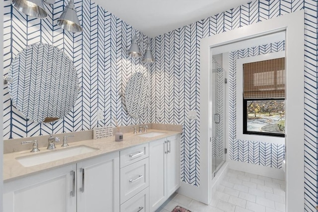 bathroom with tile patterned flooring, walk in shower, and vanity