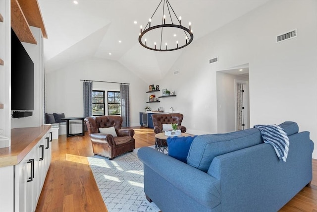 living room featuring lofted ceiling and light hardwood / wood-style flooring