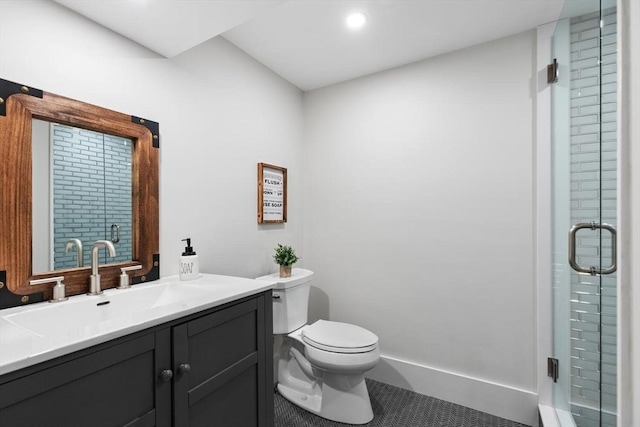 bathroom featuring toilet, a shower with door, tile patterned floors, and vanity