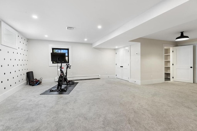 workout area with a baseboard heating unit and carpet flooring