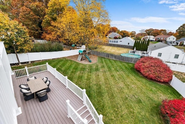 view of yard with a playground and a deck