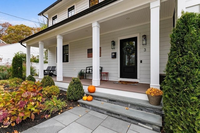 view of exterior entry with covered porch