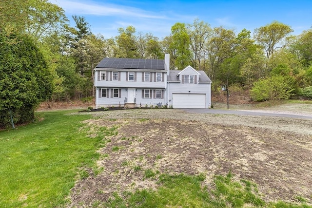 18 Candlewood Dr, Medway, MA 02053 - colonial inspired home featuring solar panels, a chimney, asphalt driveway, and a front yard