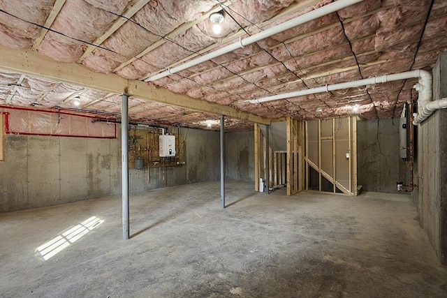 unfinished basement featuring water heater