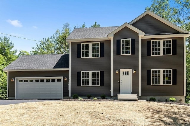 colonial-style house with dirt driveway and a garage