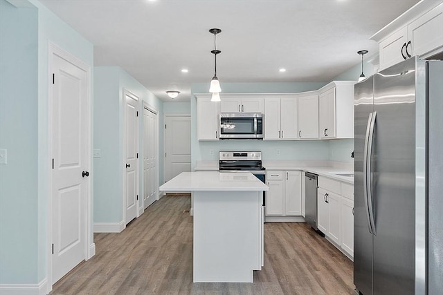 kitchen featuring white cabinetry, light wood-type flooring, appliances with stainless steel finishes, a kitchen island, and recessed lighting