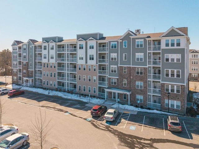 view of building exterior featuring uncovered parking