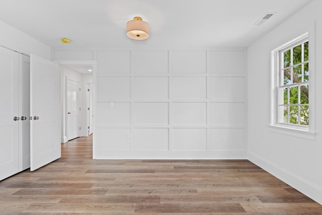 unfurnished room with a healthy amount of sunlight and light wood-type flooring