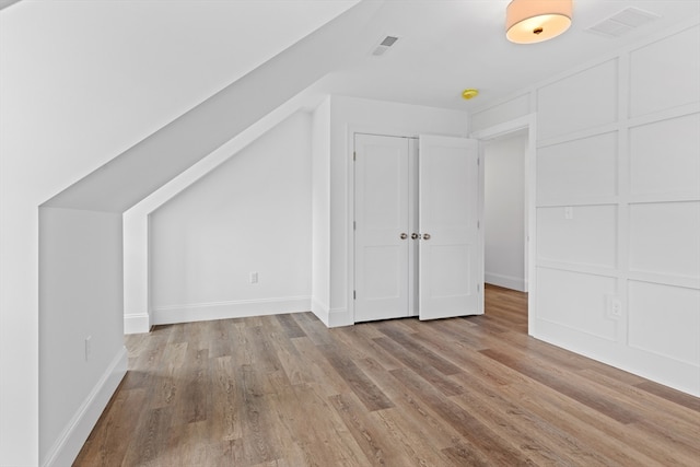 bonus room with light hardwood / wood-style flooring