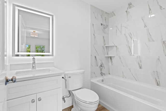 full bathroom featuring vanity, toilet, and tiled shower / bath