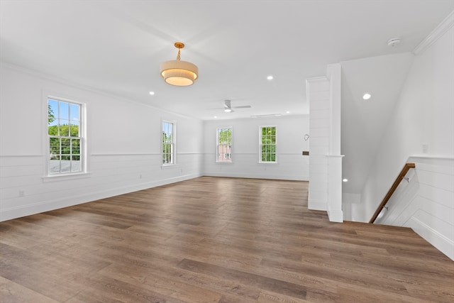 spare room with dark wood-type flooring, ceiling fan, and crown molding