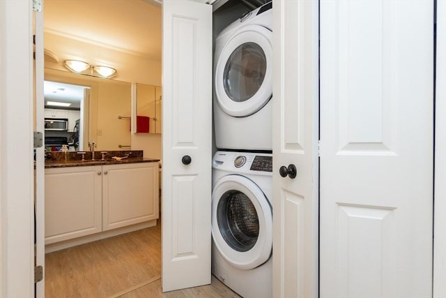 8-12 Museum Way Unit 1302, Cambridge, MA 02141 - laundry area featuring stacked washing machine and dryer and light wood-type flooring