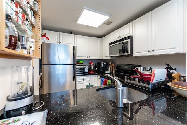 8-12 Museum Way Unit 1302, Cambridge, MA 02141 - kitchen featuring stainless steel appliances, white cabinets, and dark stone counters