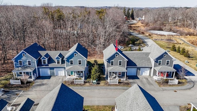 drone / aerial view with a residential view and a view of trees