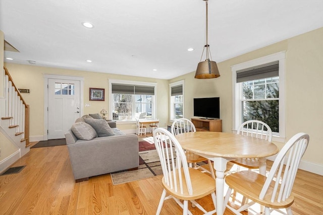 dining room featuring visible vents, recessed lighting, light wood finished floors, baseboards, and stairs