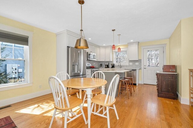 dining area with visible vents, recessed lighting, baseboards, and light wood-style floors