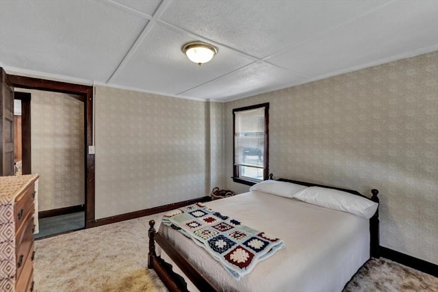 carpeted bedroom with baseboards and wallpapered walls