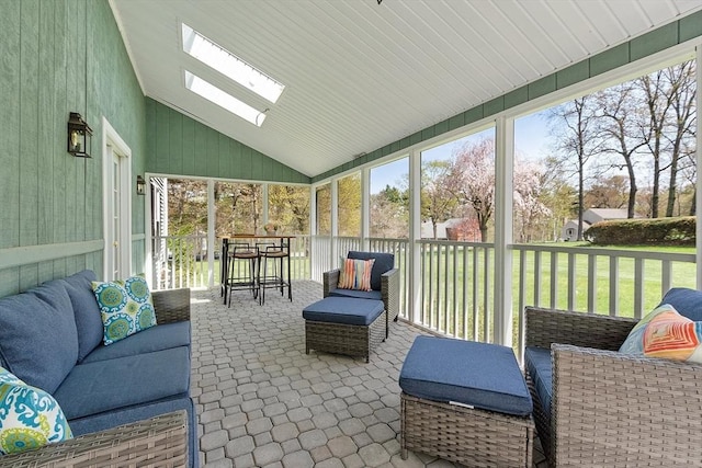 sunroom with an outdoor hangout area, a healthy amount of sunlight, and a skylight