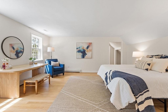 bedroom with baseboards, a baseboard heating unit, light wood-type flooring, and visible vents