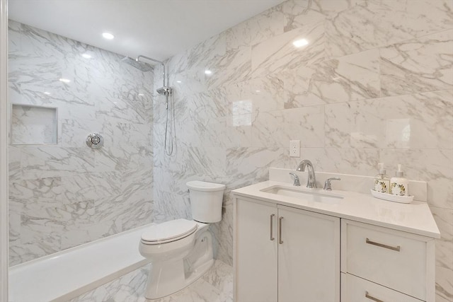 full bath featuring vanity, marble finish floor, a shower, toilet, and tile walls