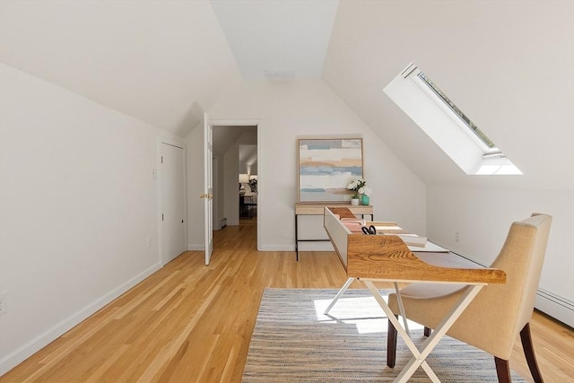 office space featuring baseboards, wood finished floors, and vaulted ceiling with skylight