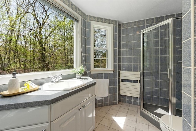 full bath featuring vanity, toilet, tile patterned floors, and a stall shower