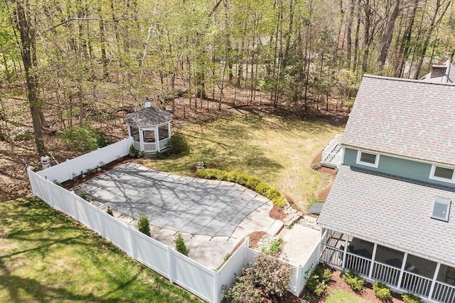 birds eye view of property featuring a view of trees